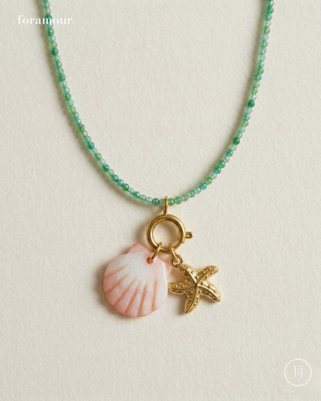 Necklace with shell and starfish charms on a light background