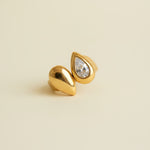 Gold ring with a diamond on a beige background
