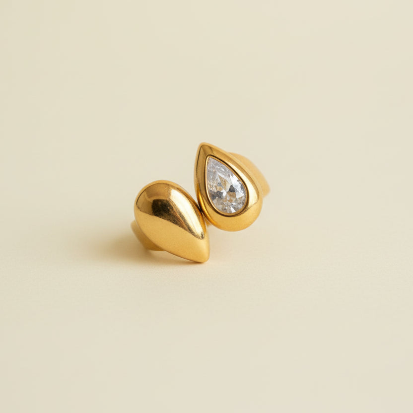 Gold ring with a diamond on a beige background
