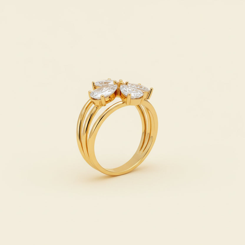 Gold ring with a diamond on a beige cushion against a light gray background