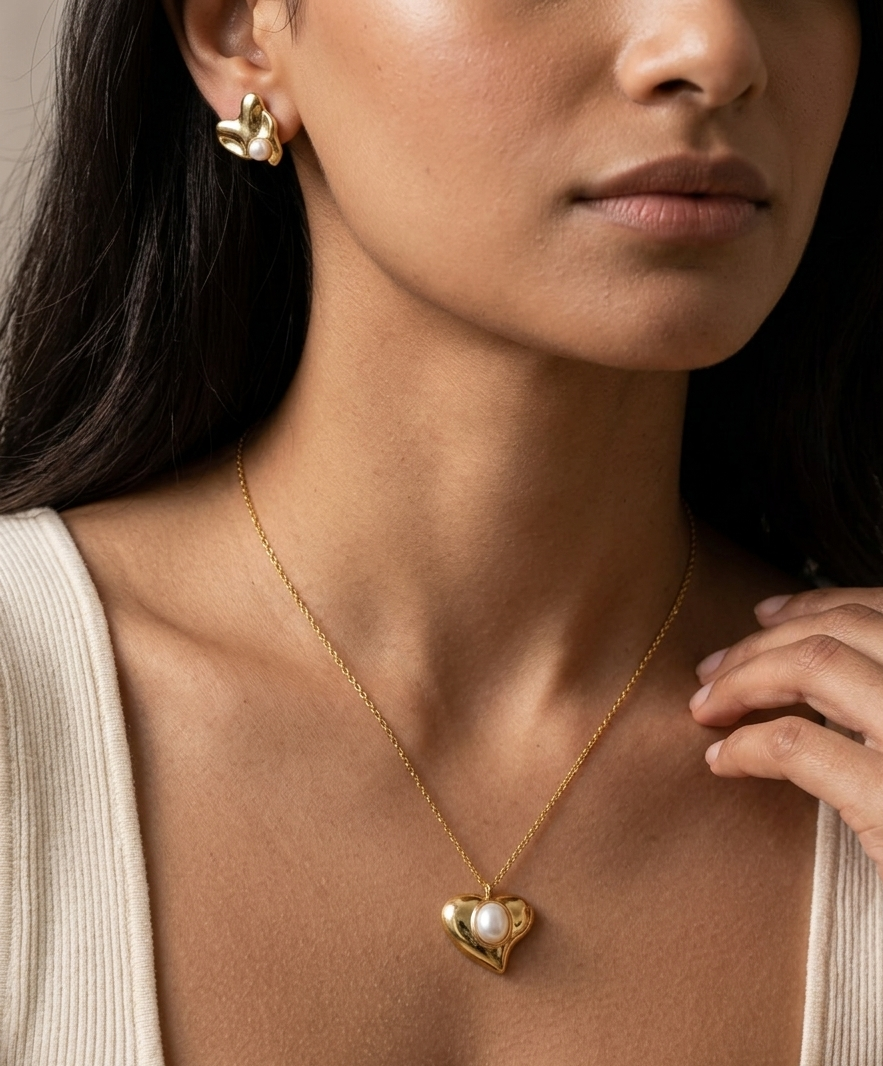 Woman wearing a gold necklace with a heart-shaped pendant
