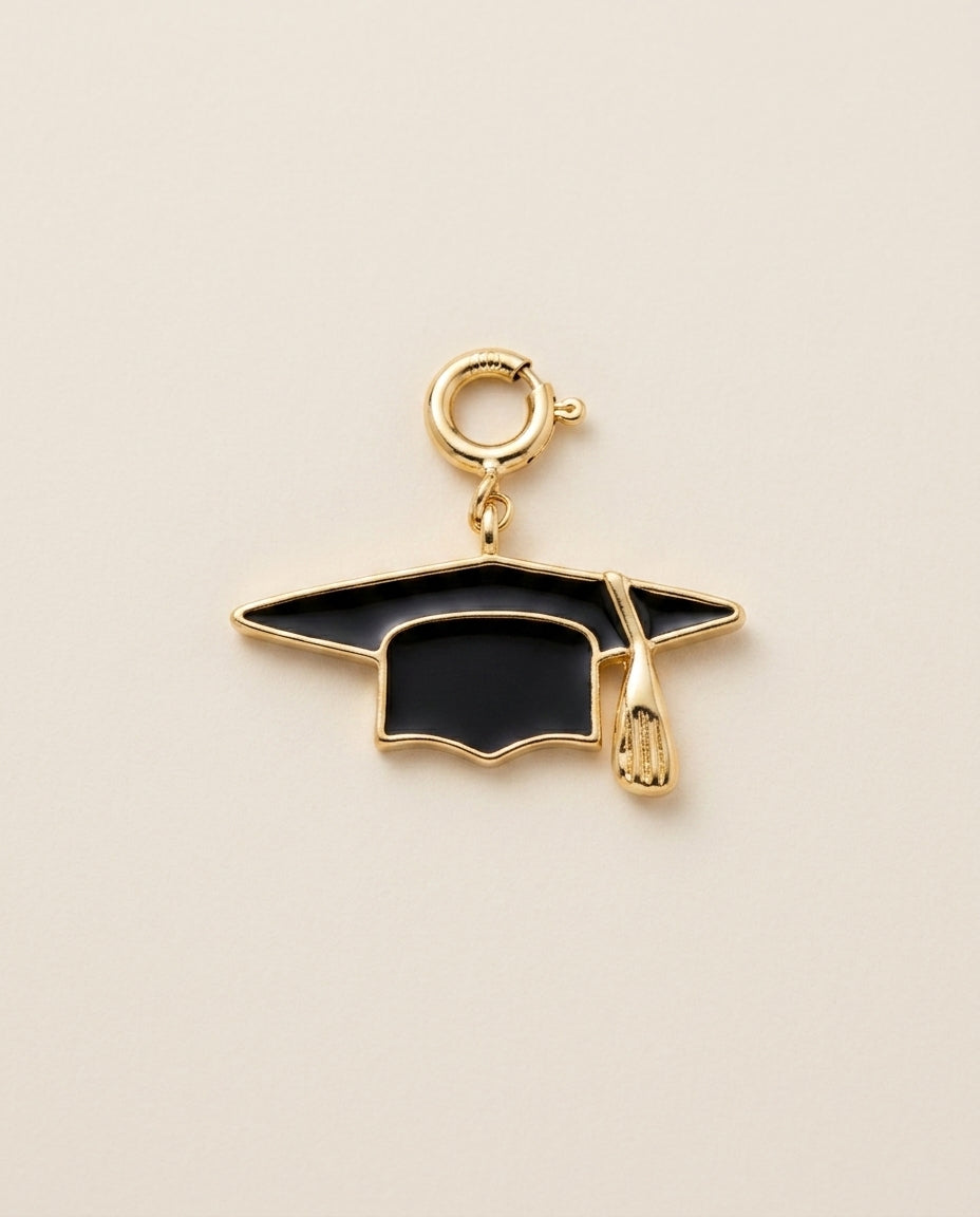 Graduation cap charm on a beige background