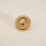 Gold decorative element on a textured stone surface