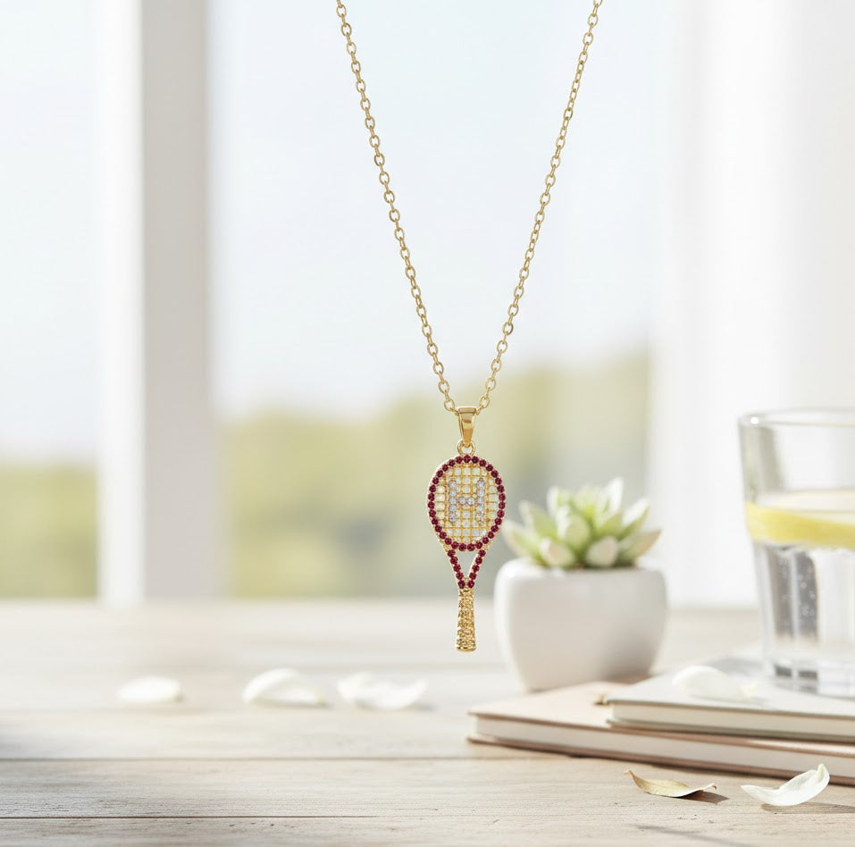 Necklace with tennis racket pendant on a table with a blurred background