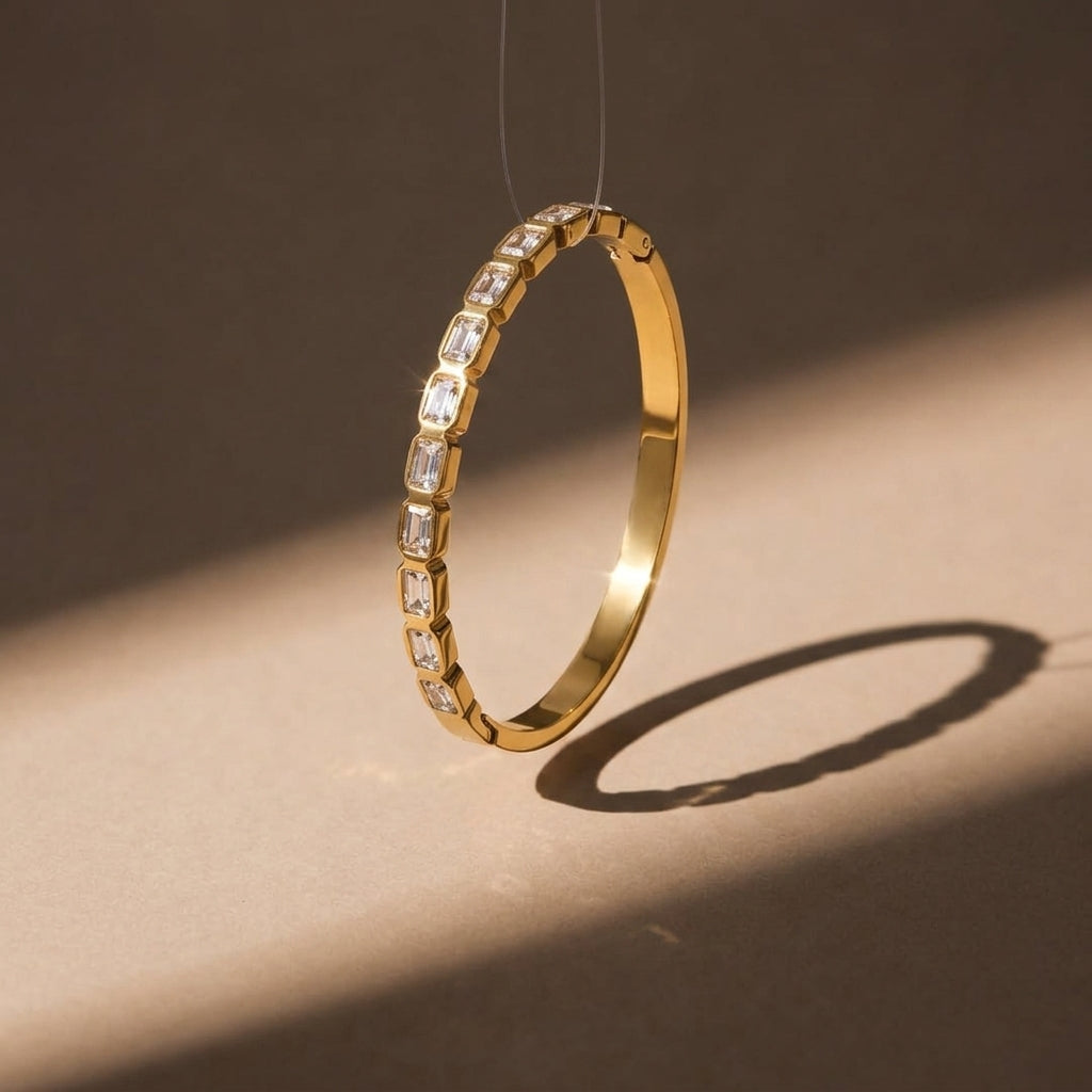 Gold ring with embedded diamonds on a brown background
