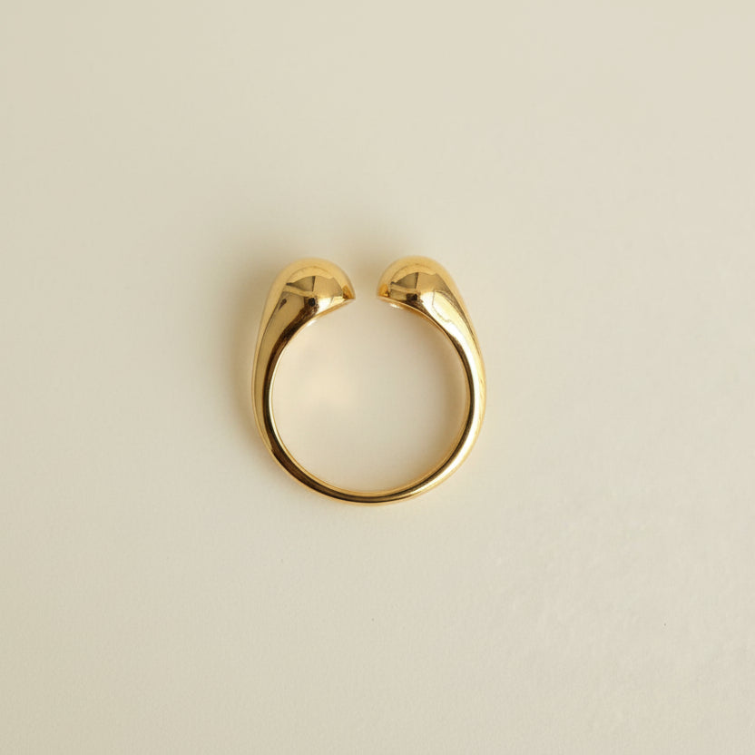 Gold ring on a light gray background