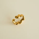 Gold chain earring on a light gray background
