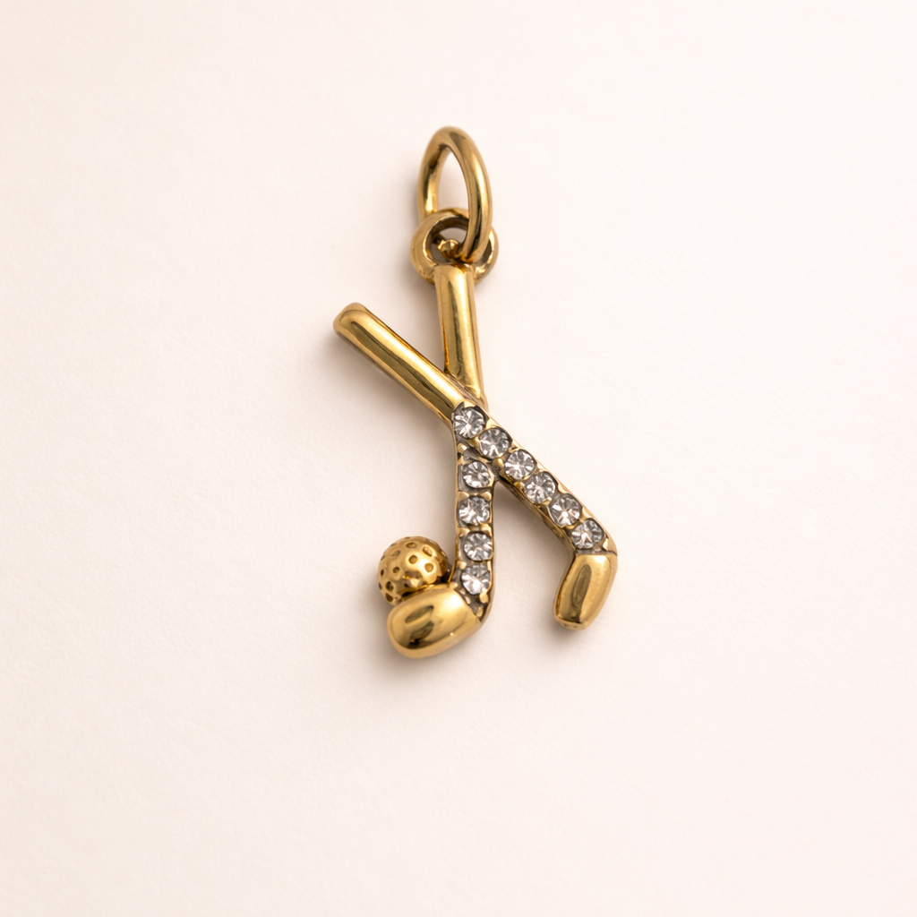 Gold and diamond charm on a beige background