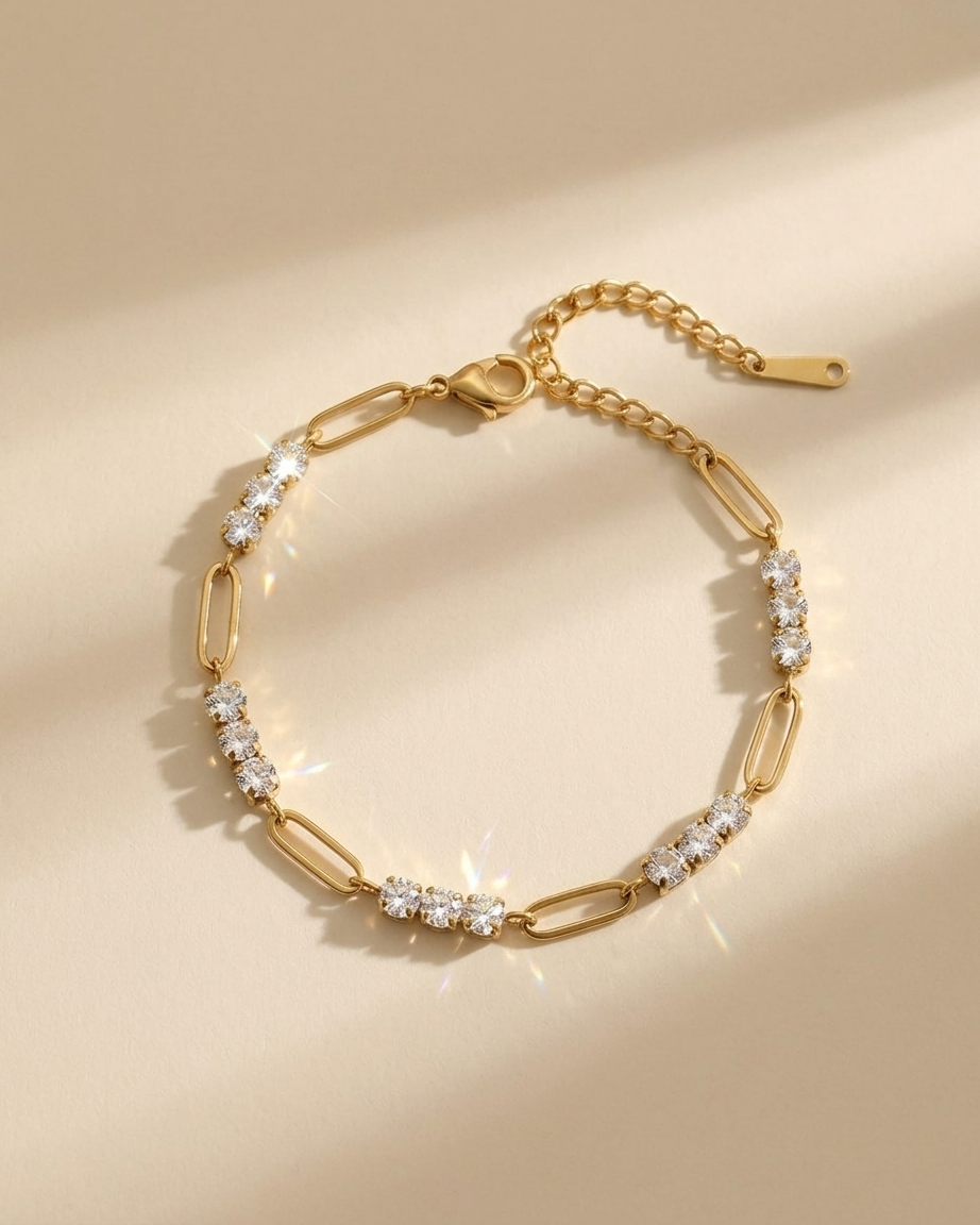 Gold bracelet with diamond accents on a beige background
