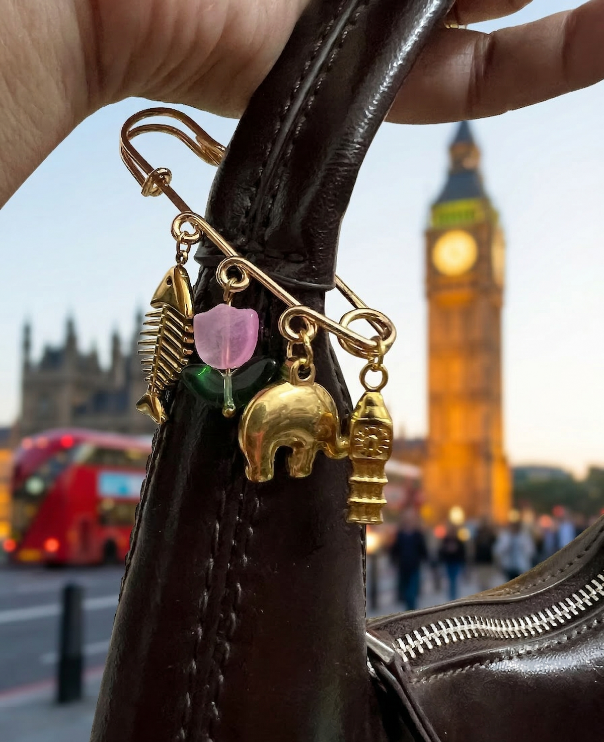 Decorative keychain with charms on a bag against the backdrop of Big Ben and a red double-decker bus.