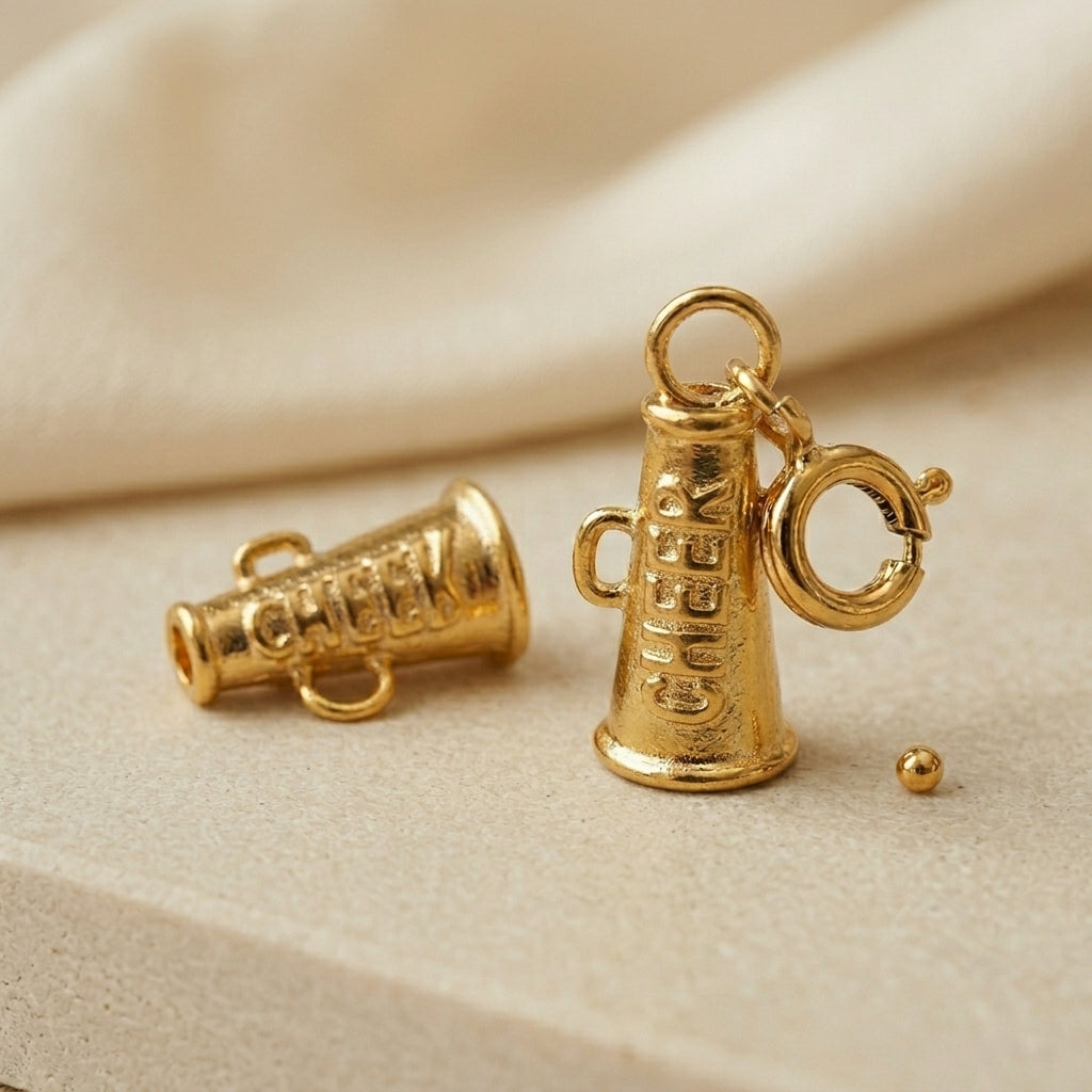Gold megaphone charm on a beige background