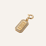 Gold charm with ticket design on a white background