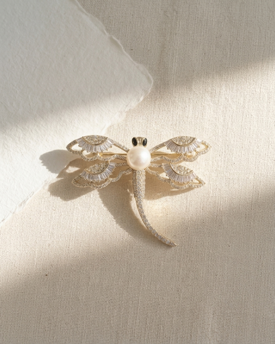 Decorative brooch with pearl center on a textured beige background