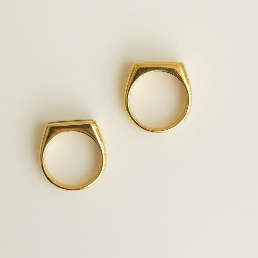 Two gold and white size markers on a light gray background