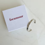 Silver bracelet on a white box with 'Foramour' branding.
