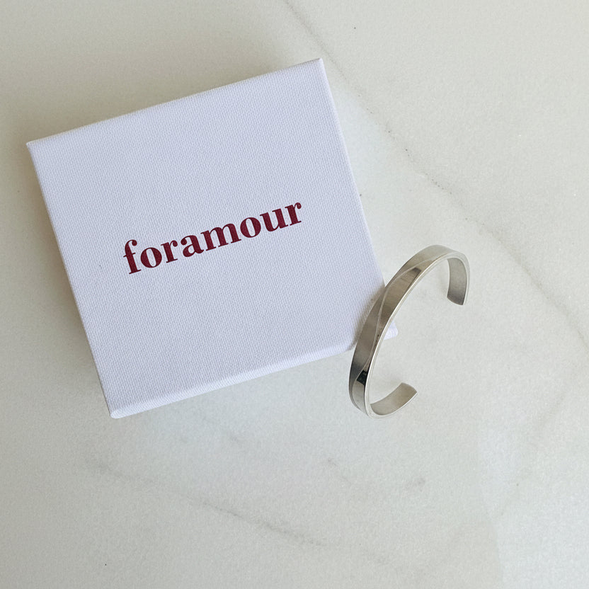 Silver bracelet on a white box with 'Foramour' branding.