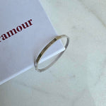 Silver bracelet on a white box with 'Foramour' branding.