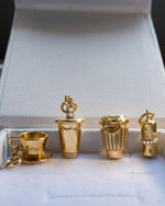 Set of gold-colored jewelry pieces on a textured surface