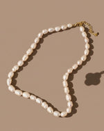 Pearl necklace on a beige background
