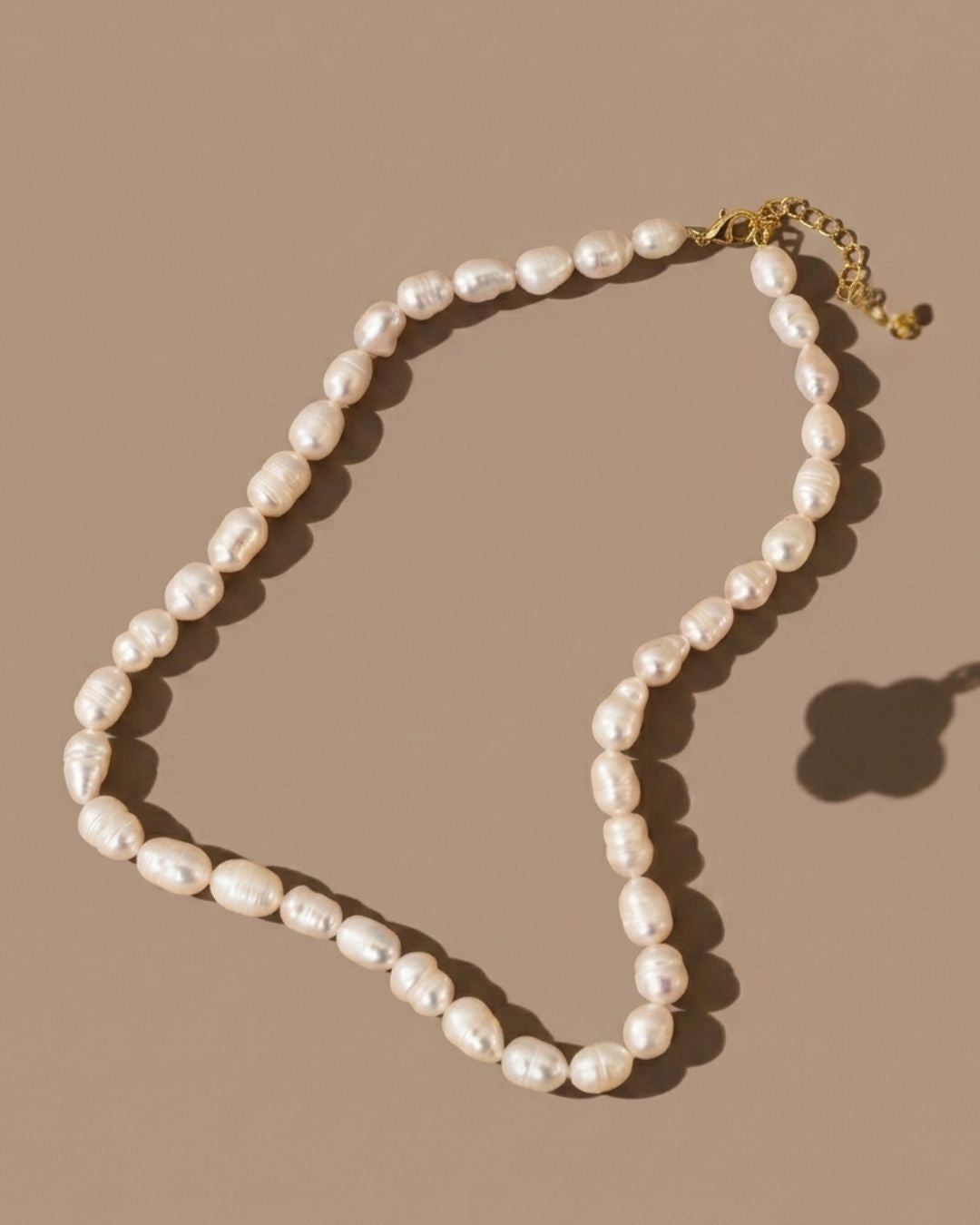 Pearl necklace on a beige background
