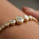 Gold bracelet with diamonds on a person's wrist