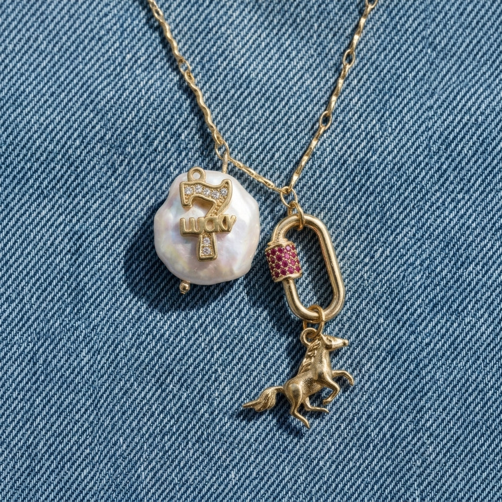 Necklace with a pearl pendant and horse charm on a denim background