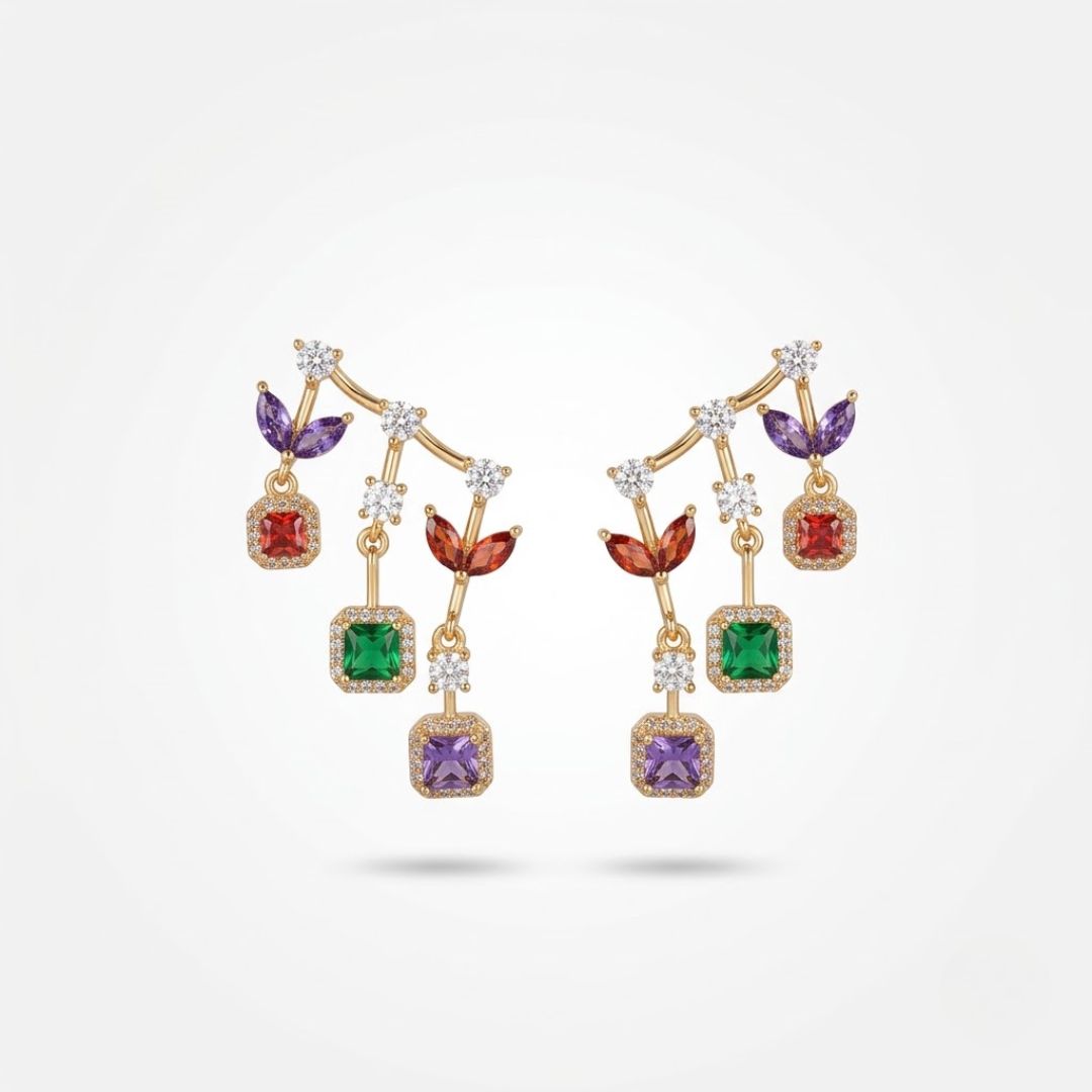 Long gold drop earrings with purple, red, emerald and amethyst halo stones stacked vertically on white surface