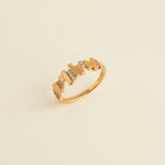 Gold ring with a unique design on a light gray background
