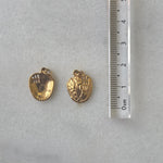 Gold baseball glove charm on a marble surface