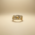 Gold ring with diamond accents on a beige background