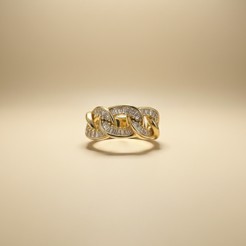 Gold ring with diamond accents on a beige background