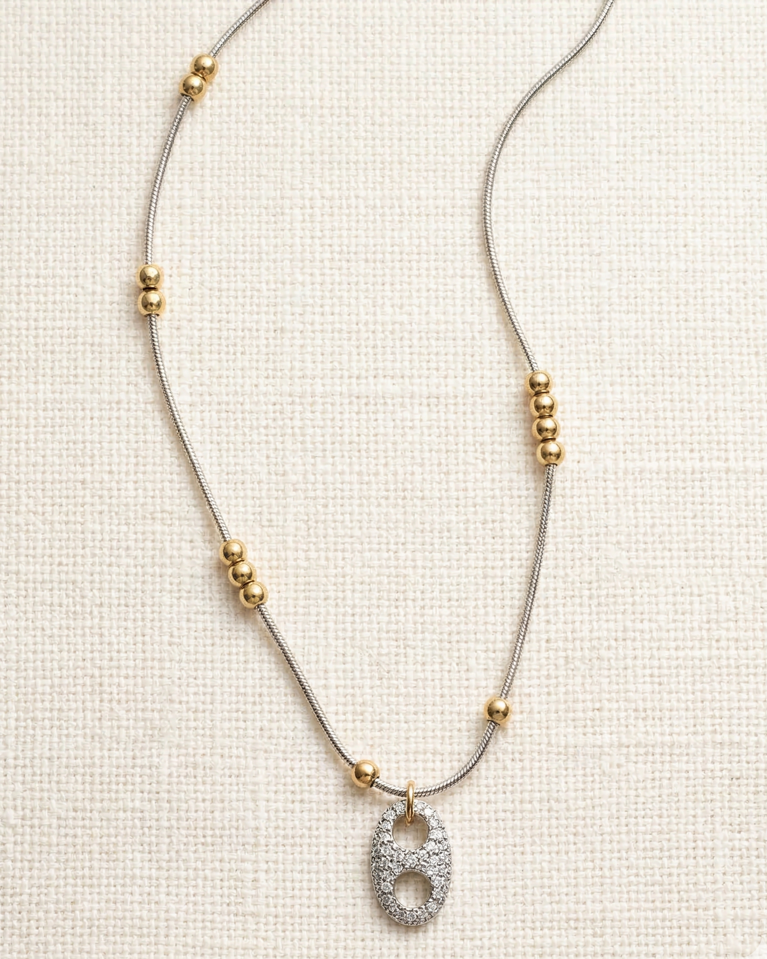 Necklace with a decorative pendant on a light background