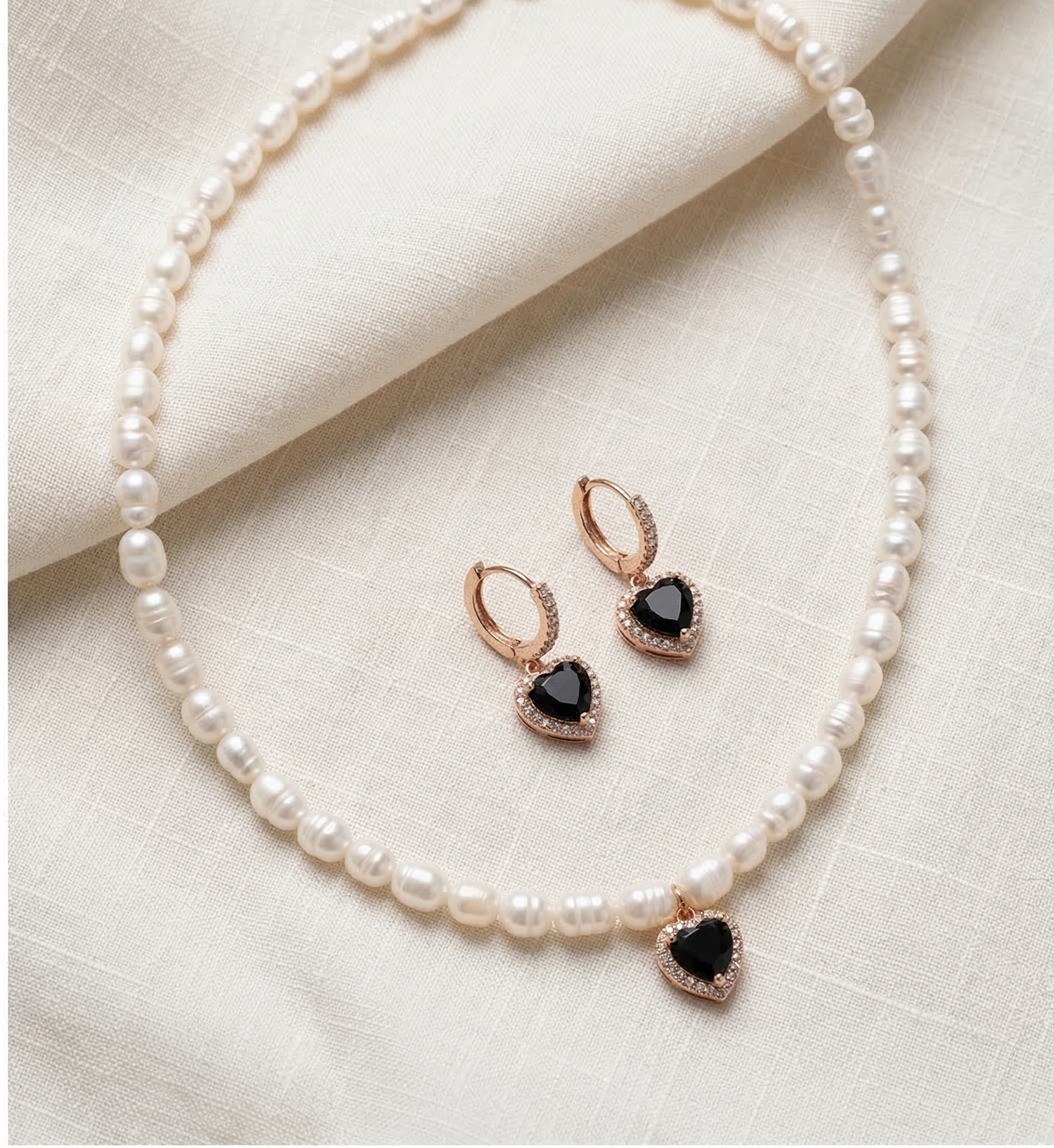 Pearl necklace and earrings set on a light fabric background with 'Dark Romance Pearl Set' text.