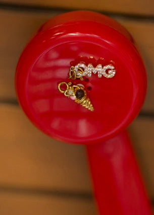 Red object with gold charms on a wooden surface
