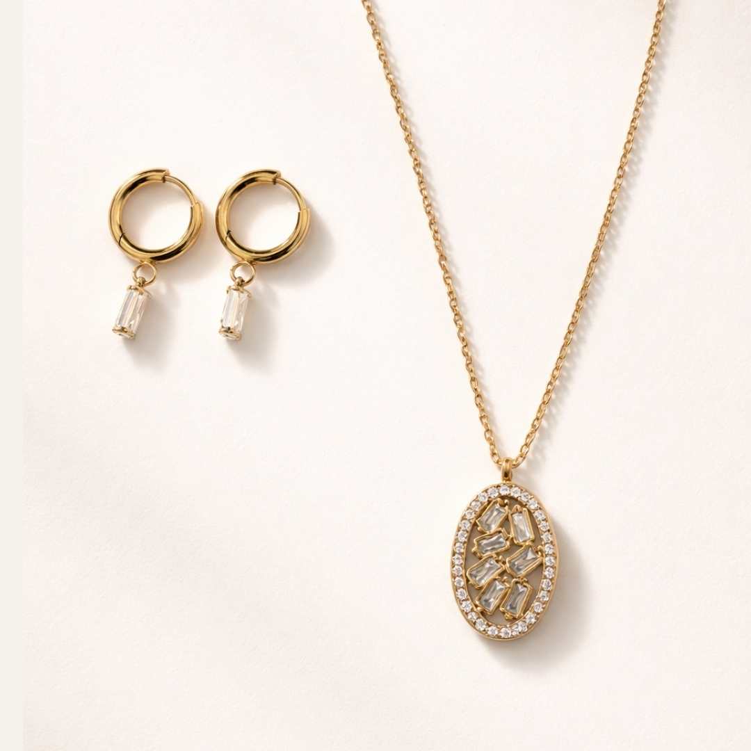 Gold necklace and earrings on a light beige background