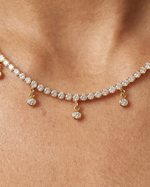 Rose gold necklace with diamonds on a person's neck