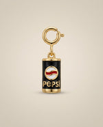 Pepsi charm with gold accents on a beige background