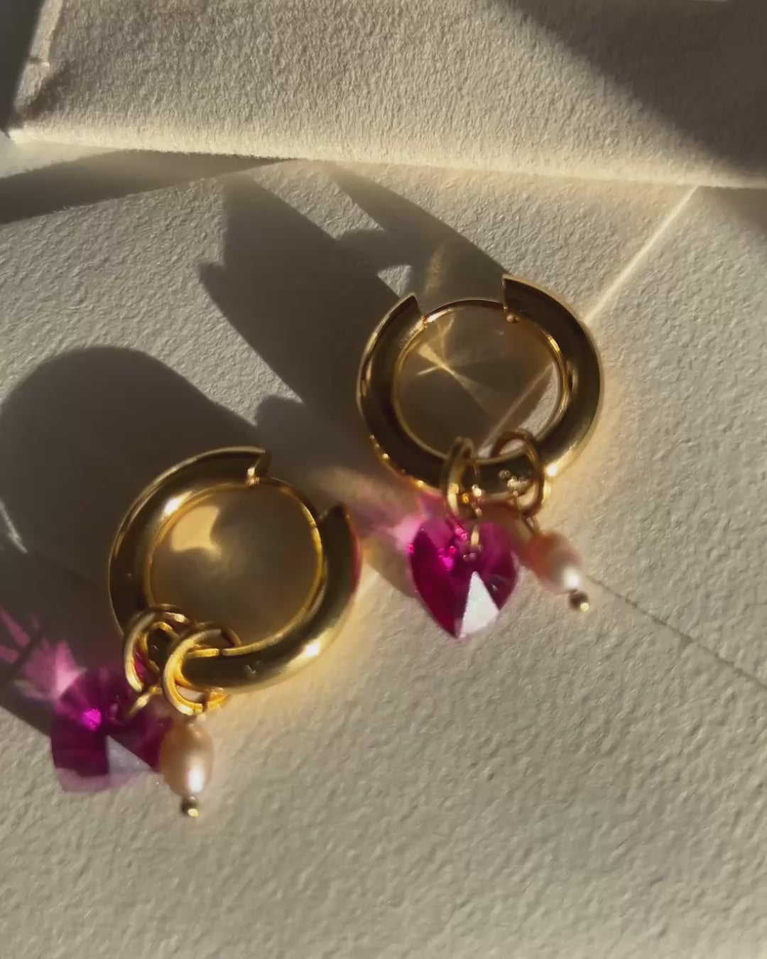 video of earrings with pink crystal and pearl