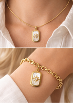 Gold necklace and bracelet with a star pendant worn by a person.