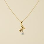 Gold necklace with a small pendant on a white background