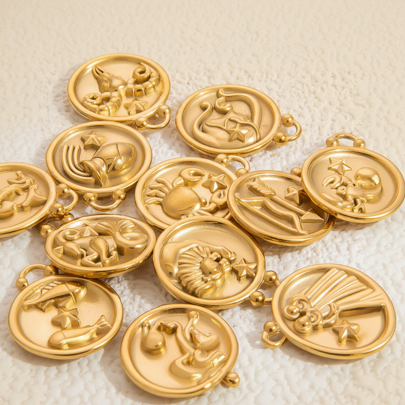 Gold zodiac medallions on a textured white background